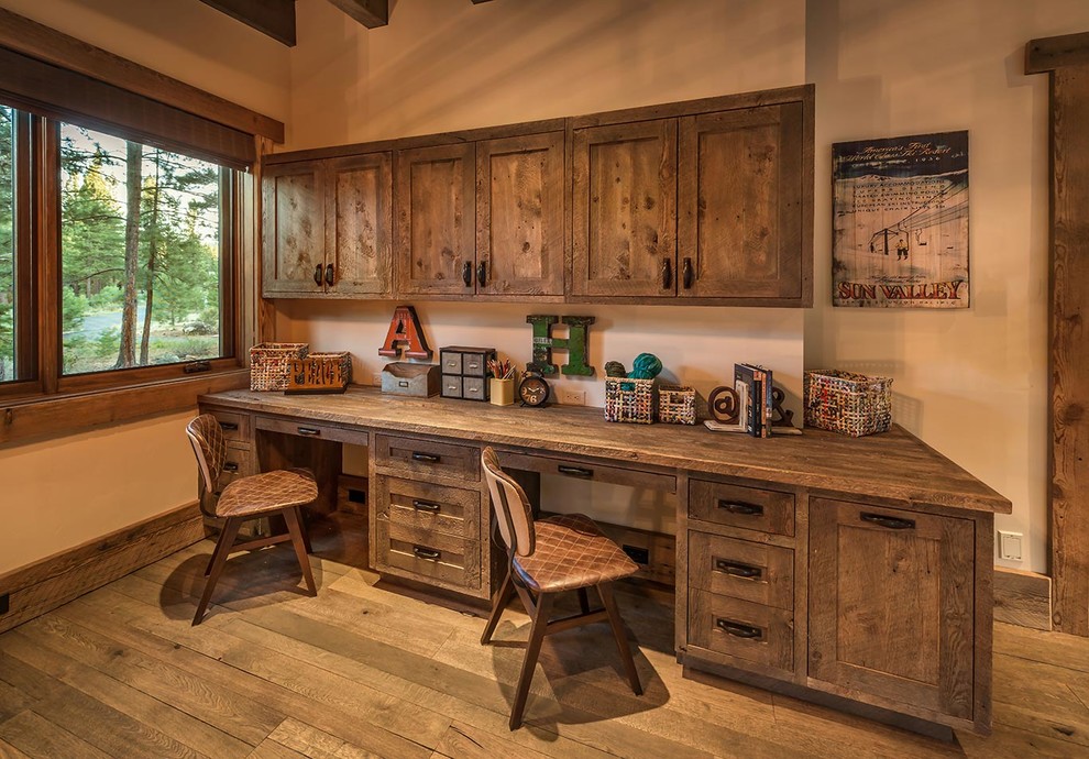 Inspiration for a rustic home office in Sacramento with beige walls, dark hardwood flooring and a built-in desk.