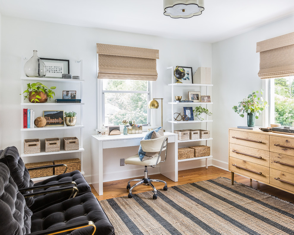 Inspiration for a traditional study in Seattle with white walls, medium hardwood flooring, a freestanding desk and brown floors.