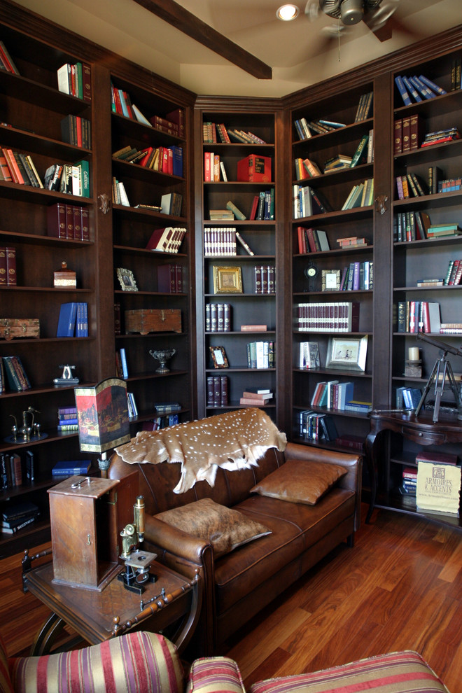 オースティンにある高級な広いトラディショナルスタイルのおしゃれなホームオフィス・書斎 (ライブラリー、ベージュの壁、無垢フローリング) の写真
