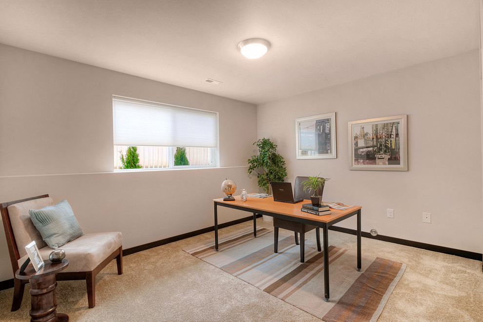 Large contemporary study in Seattle with white walls, carpet and a freestanding desk.