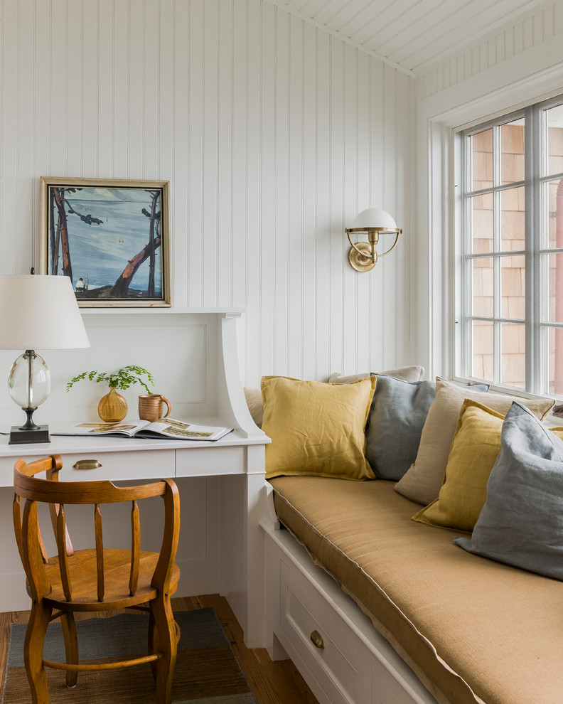 Maritimes Arbeitszimmer mit Arbeitsplatz, braunem Holzboden, Einbau-Schreibtisch und weißer Wandfarbe in Boston