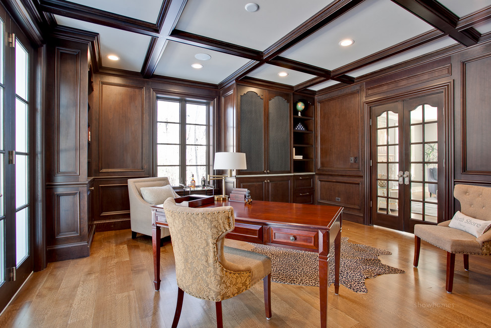 Example of a mid-sized classic freestanding desk light wood floor home office library design in Chicago