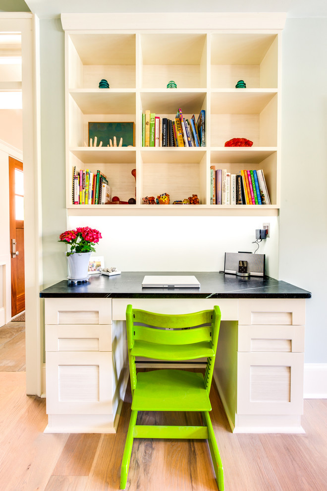 This is an example of a classic home office in Other with a built-in desk and grey walls.