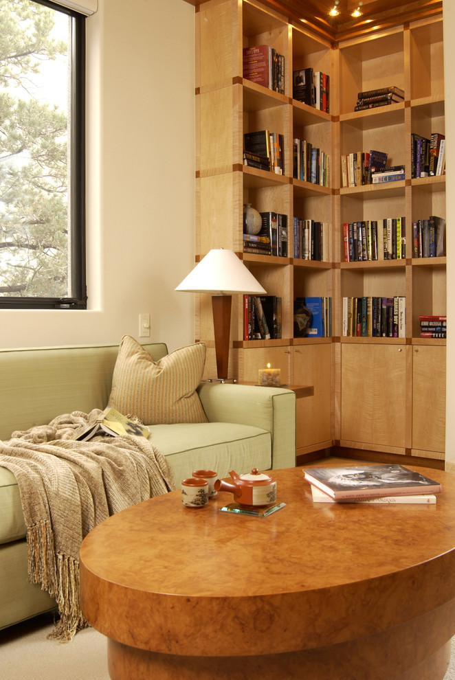 На фото: домашняя библиотека среднего размера в современном стиле с бежевыми стенами с