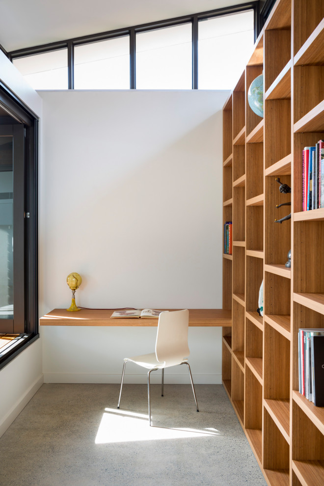 Идея дизайна: кабинет среднего размера в современном стиле с белыми стенами, бетонным полом, серым полом и встроенным рабочим столом без камина