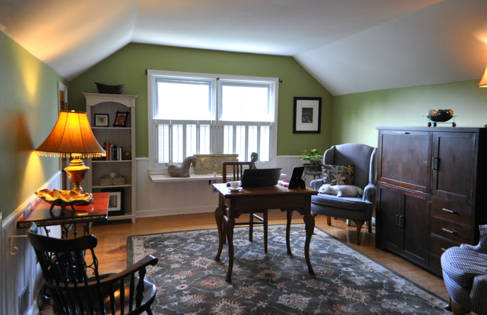 Ejemplo de despacho tradicional renovado con paredes verdes, suelo de madera clara y escritorio independiente