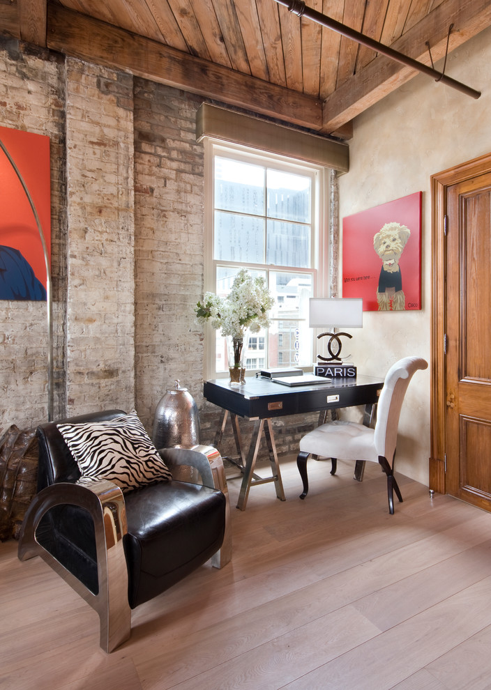 Example of an urban freestanding desk light wood floor and beige floor home office design in New Orleans with beige walls