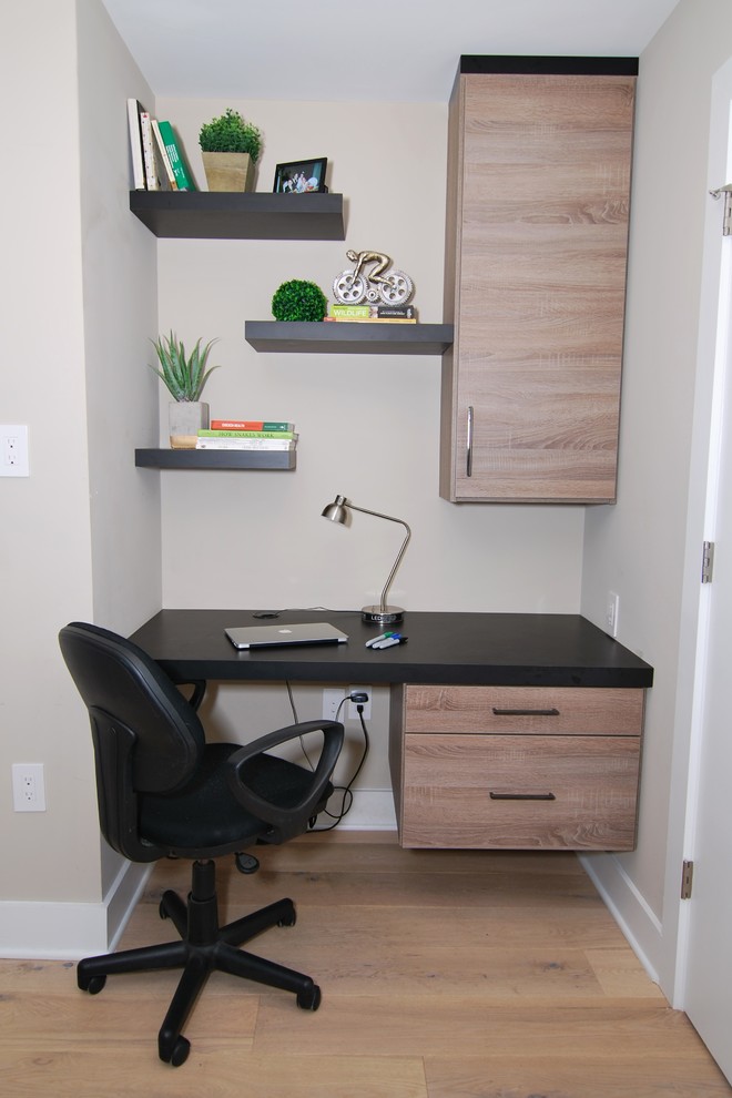 Small contemporary home office in Philadelphia with brown walls, medium hardwood flooring, a built-in desk and beige floors.