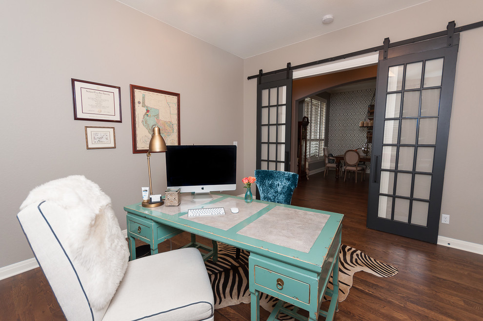 Medium sized bohemian home office in Austin with grey walls, dark hardwood flooring and a freestanding desk.