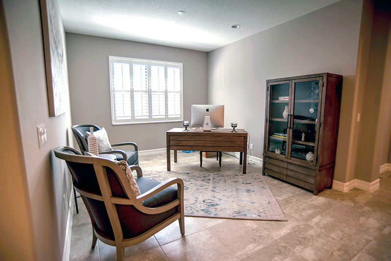 Small traditional home office in Orlando with grey walls, porcelain flooring, no fireplace, a freestanding desk and beige floors.