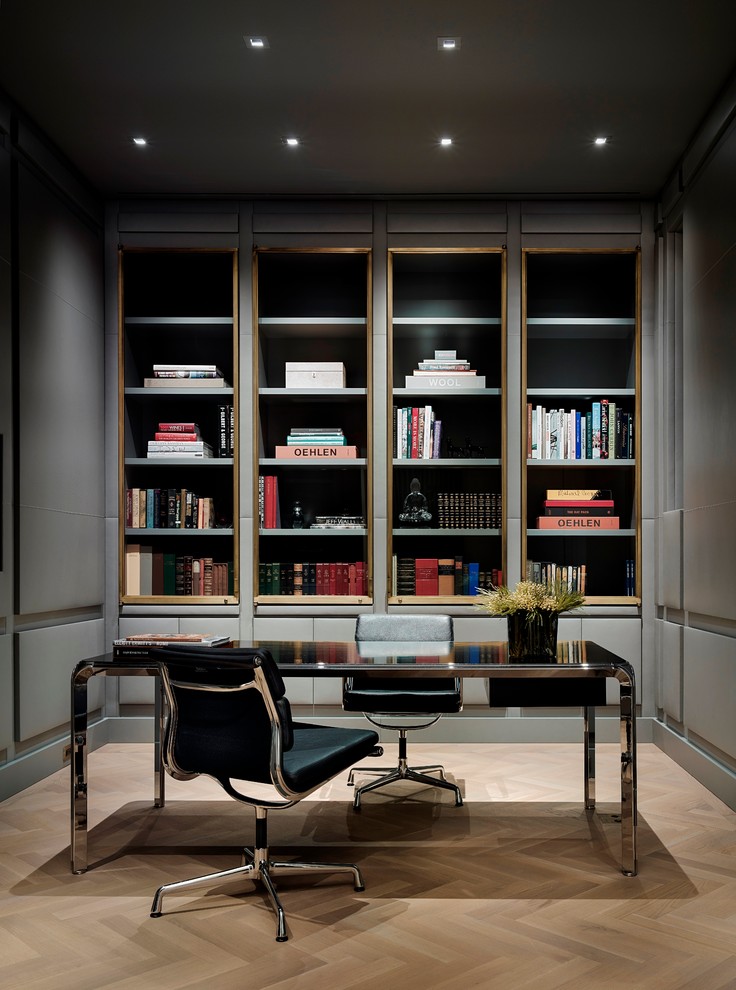 Foto de despacho contemporáneo de tamaño medio con paredes grises, suelo de madera clara y escritorio independiente