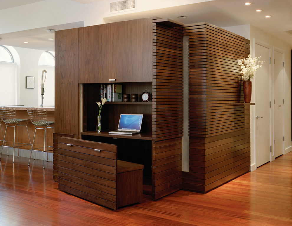 Inspiration for a contemporary built-in desk medium tone wood floor study room remodel in New York