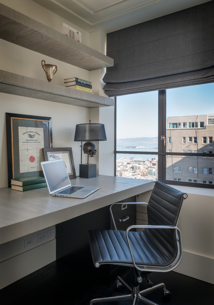 This is an example of a classic study in San Francisco with white walls, dark hardwood flooring and a built-in desk.