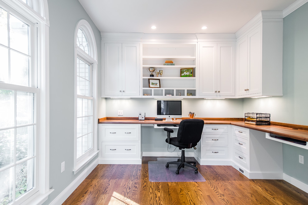 Mid-sized elegant built-in desk dark wood floor study room photo in Boston with gray walls and no fireplace