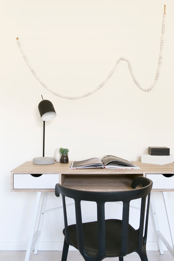 Danish freestanding desk light wood floor study room photo in Sydney with white walls