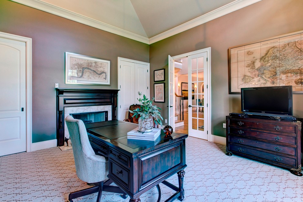 Large elegant freestanding desk carpeted study room photo in Raleigh with brown walls, a standard fireplace and a stone fireplace