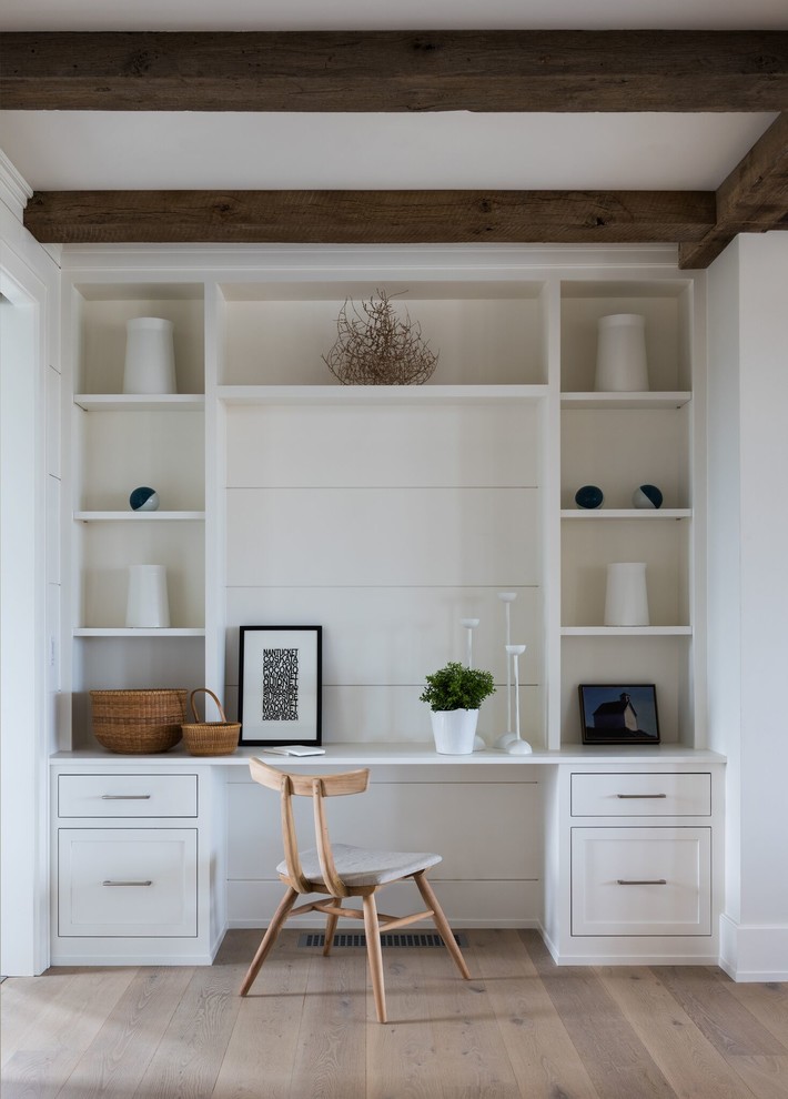 Example of a mid-sized beach style built-in desk light wood floor and beige floor study room design in Providence with white walls and no fireplace