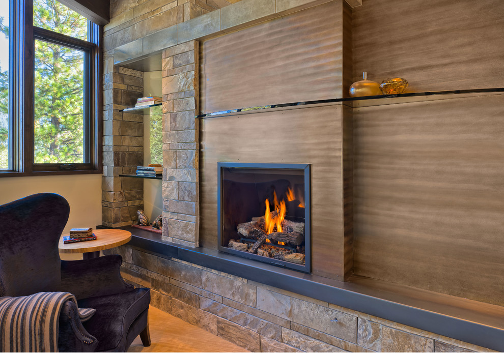 Design ideas for a medium sized contemporary study in Sacramento with beige walls, light hardwood flooring, a standard fireplace and a wooden fireplace surround.