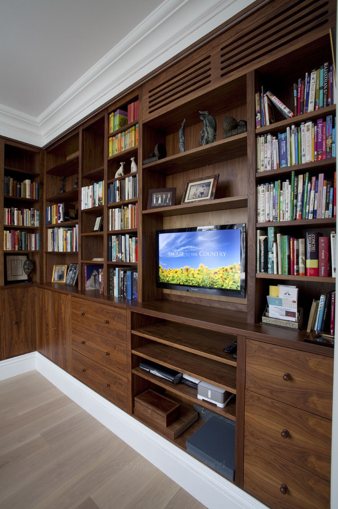 Design ideas for a large traditional study in London with medium hardwood flooring and a built-in desk.