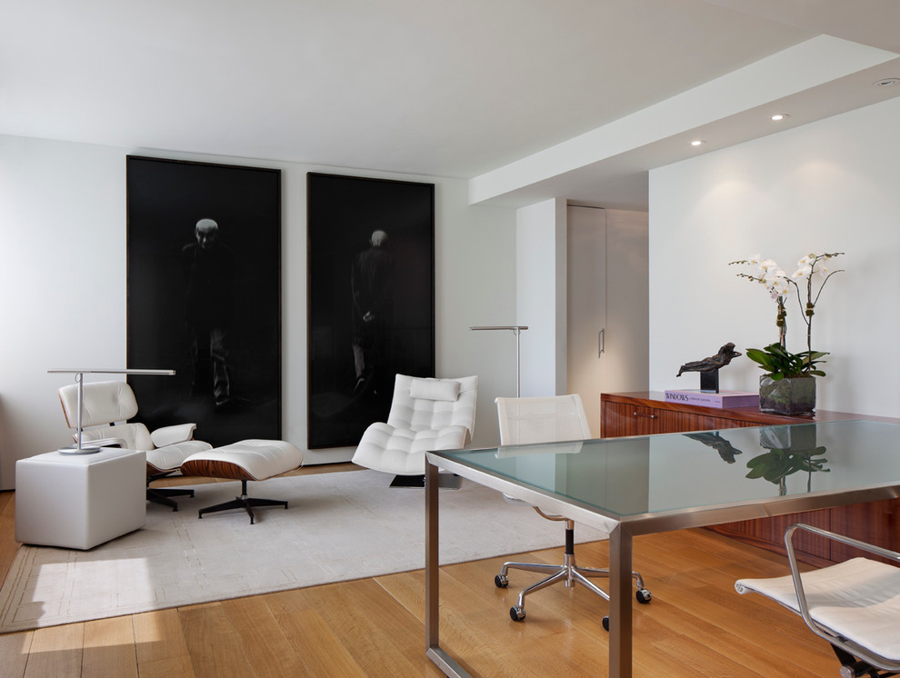 Esempio di uno studio design con pareti bianche, pavimento in legno massello medio e scrivania autoportante