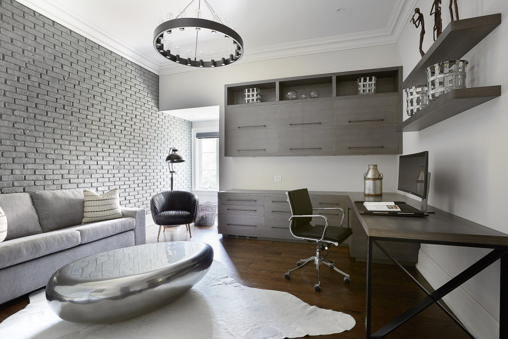 Diseño de despacho actual de tamaño medio sin chimenea con escritorio empotrado, paredes blancas, suelo de madera oscura y ladrillo