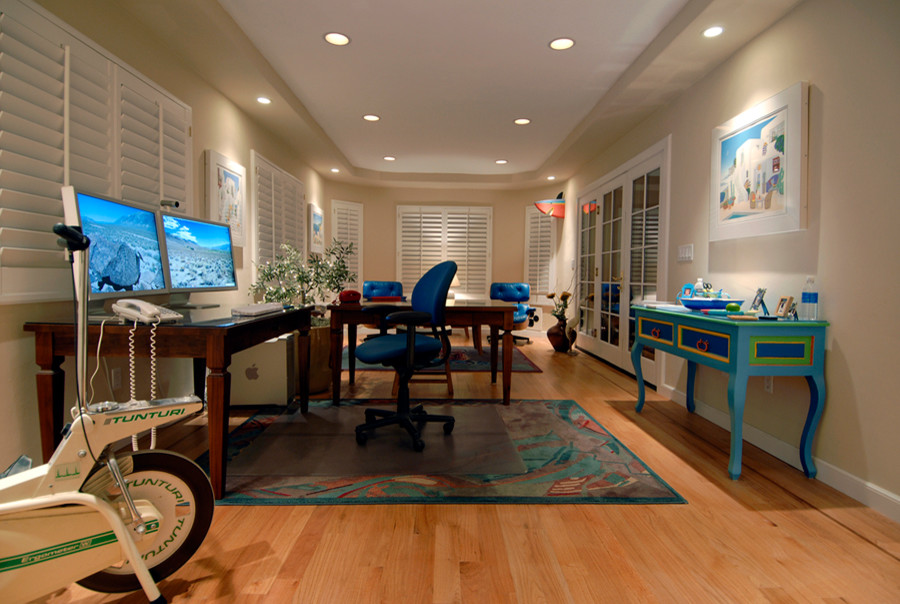 Medium sized contemporary home studio in Sacramento with beige walls, medium hardwood flooring, no fireplace and a freestanding desk.