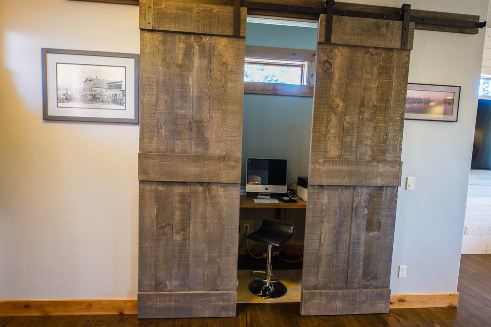 Exemple d'un petit bureau chic avec parquet foncé, aucune cheminée, un bureau intégré et un mur gris.