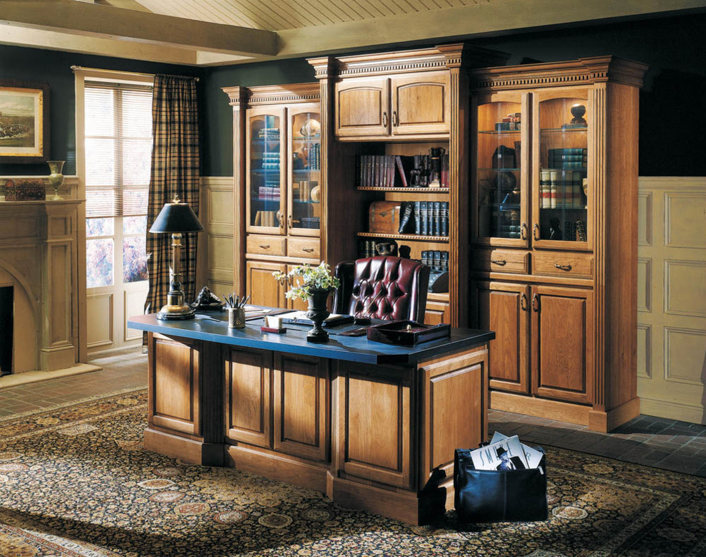 Example of a mid-sized classic freestanding desk brick floor and beige floor home office library design in Boston with blue walls, a standard fireplace and a plaster fireplace