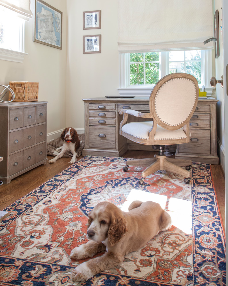 Inspiration for a mid-sized transitional freestanding desk medium tone wood floor home office remodel in Charlotte with beige walls