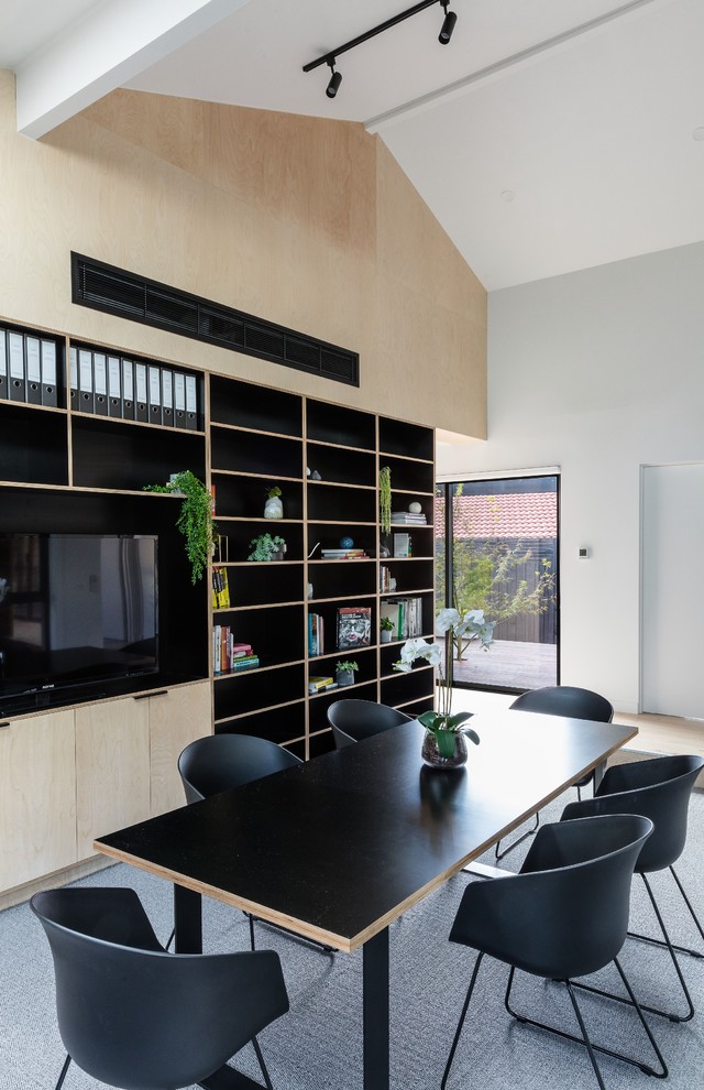 Cette photo montre un bureau moderne de taille moyenne et de type studio avec un mur blanc, moquette, un bureau intégré et un sol gris.