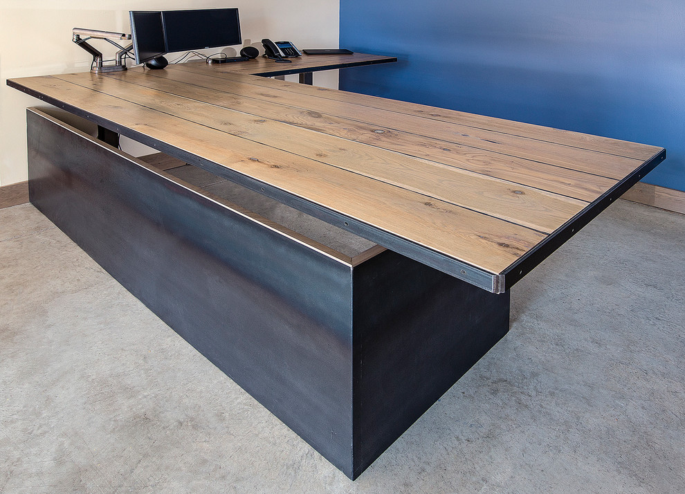 Study room - large industrial freestanding desk concrete floor study room idea in Denver