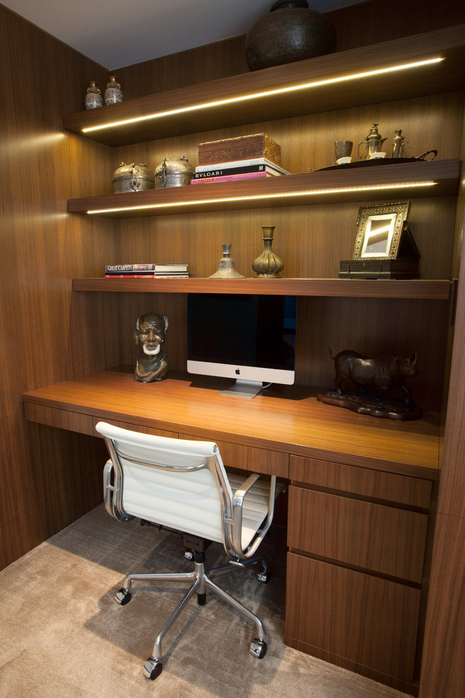 Example of a small trendy built-in desk carpeted study room design in Vancouver with brown walls and no fireplace