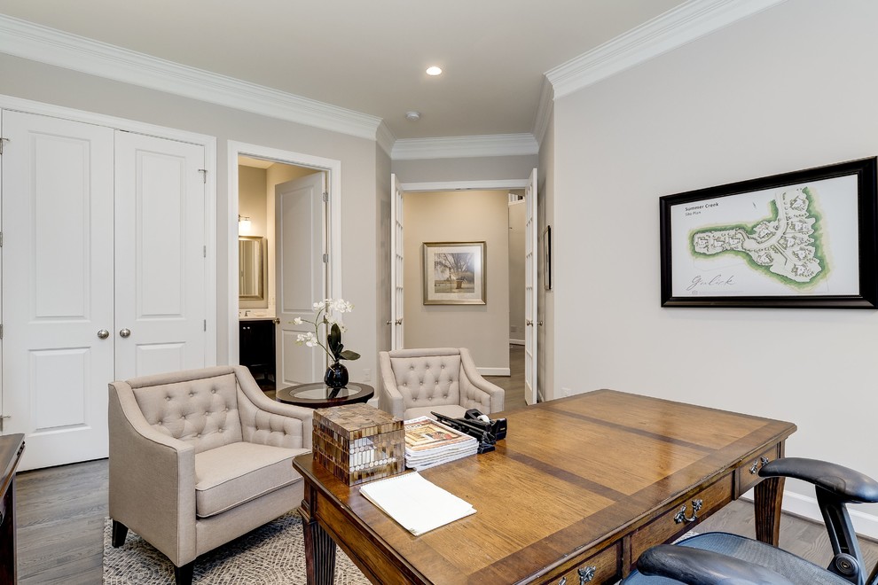 Photo of a medium sized traditional study in DC Metro with grey walls, medium hardwood flooring, no fireplace, a freestanding desk and brown floors.