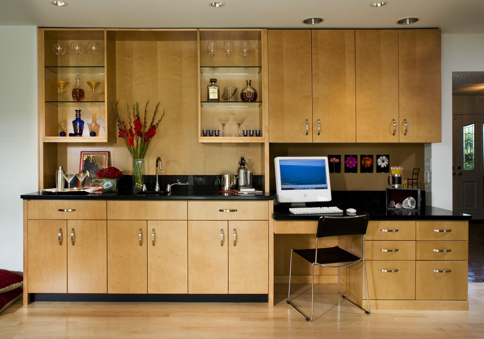 This is an example of a contemporary home office in San Francisco with a built-in desk.