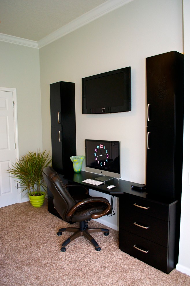 Foto di un ufficio minimalista con pareti grigie, moquette e scrivania incassata