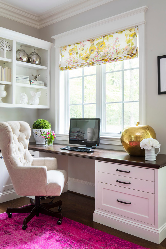 Example of a classic built-in desk dark wood floor home office design in DC Metro with gray walls