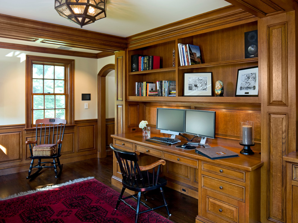 Inspiration for a mid-sized timeless built-in desk dark wood floor and brown floor study room remodel in Boston with beige walls
