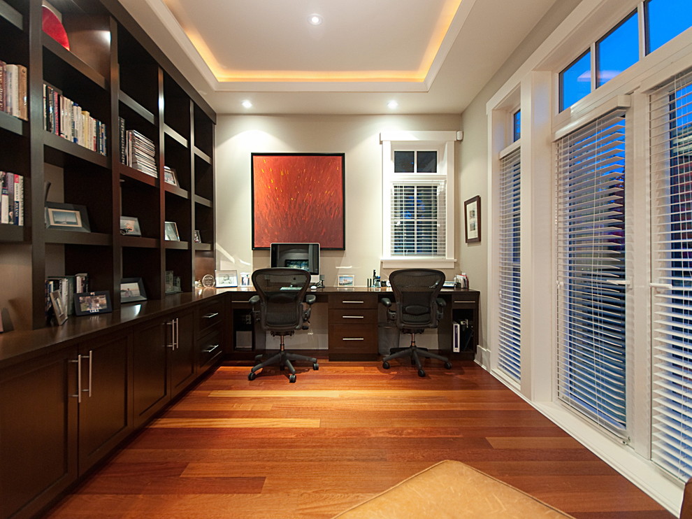 На фото: кабинет в современном стиле с серыми стенами, паркетным полом среднего тона и встроенным рабочим столом