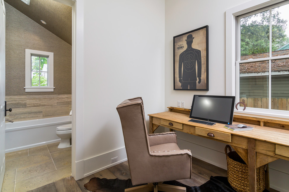 Medium sized beach style home office in Atlanta with beige walls and dark hardwood flooring.