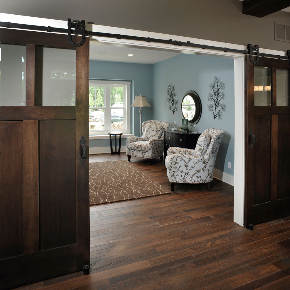 This is an example of a rustic home office in Columbus with blue walls, dark hardwood flooring and a freestanding desk.