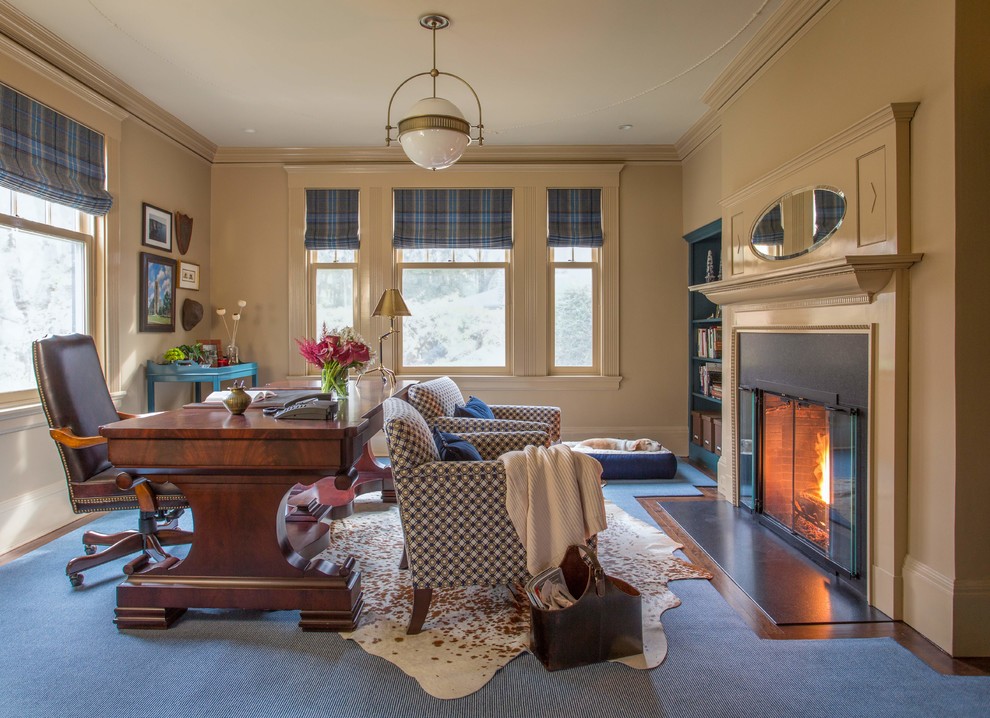 Medium sized classic study in Boston with beige walls, dark hardwood flooring, a standard fireplace, a stone fireplace surround, a freestanding desk and a chimney breast.