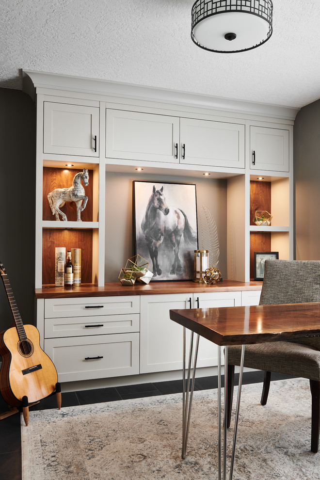 Imagen de despacho clásico renovado de tamaño medio sin chimenea con paredes grises, suelo de baldosas de porcelana, escritorio independiente y suelo negro