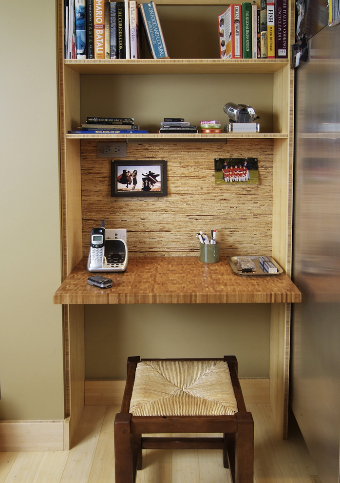 Small minimalist built-in desk light wood floor and beige floor home office photo in Other with beige walls