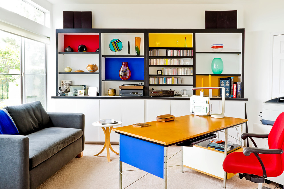 Example of a mid-sized trendy freestanding desk carpeted study room design in Orange County with white walls and no fireplace