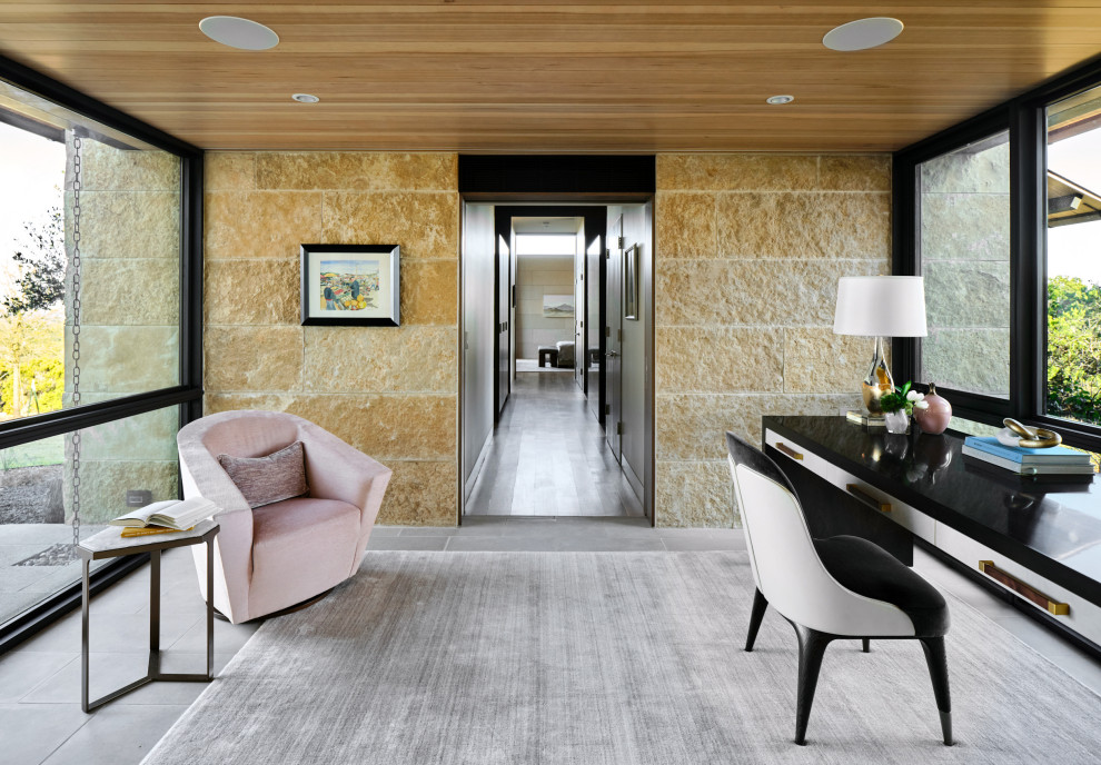 Inspiration for a small contemporary study in Austin with limestone flooring, a freestanding desk, a wood ceiling, brown walls and grey floors.