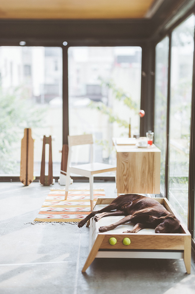 Foto de despacho minimalista grande sin chimenea con paredes beige, suelo de cemento, escritorio independiente y suelo gris