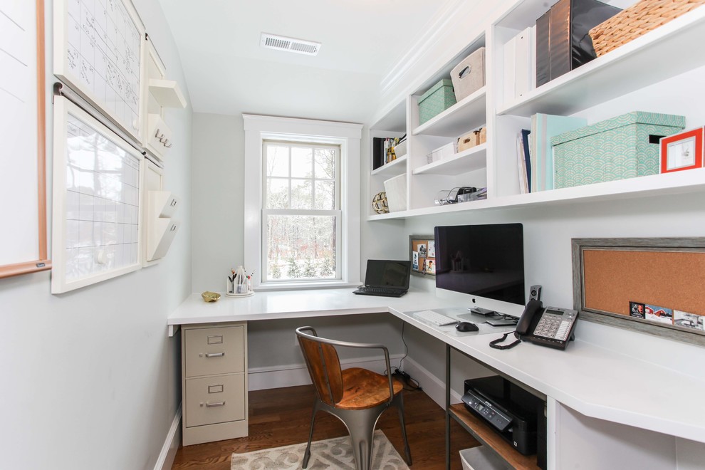 Modelo de despacho clásico renovado pequeño con paredes grises, suelo de madera en tonos medios y escritorio empotrado
