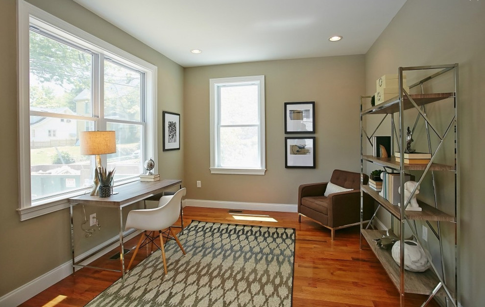 Ejemplo de despacho minimalista de tamaño medio con paredes beige, suelo de madera en tonos medios, escritorio independiente y suelo marrón