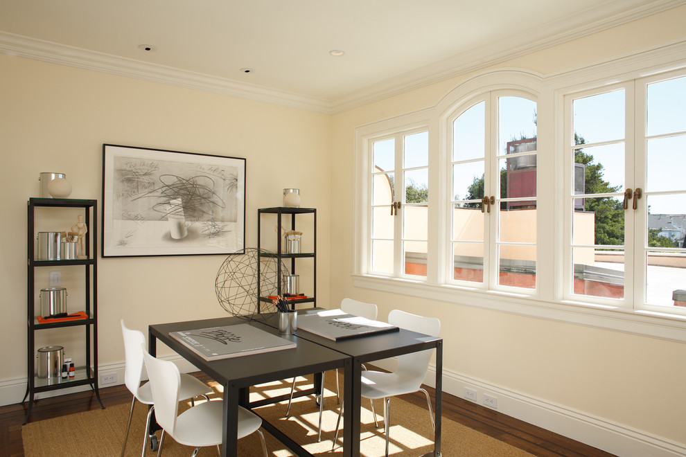 Example of a large trendy freestanding desk dark wood floor and brown floor craft room design in San Francisco with beige walls and no fireplace