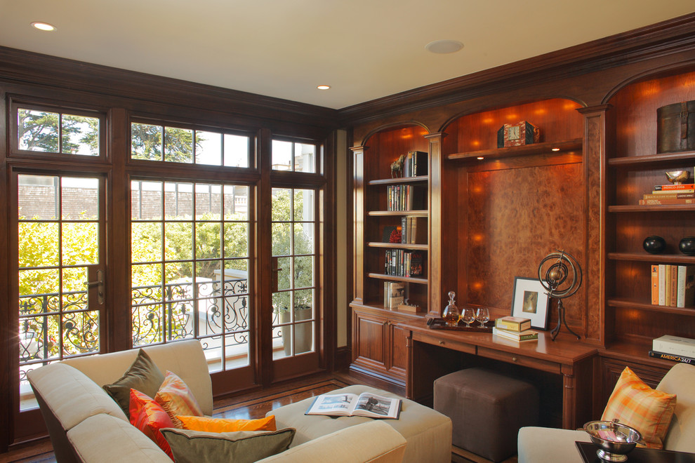 Example of a mid-sized trendy built-in desk dark wood floor study room design in San Francisco with beige walls and no fireplace
